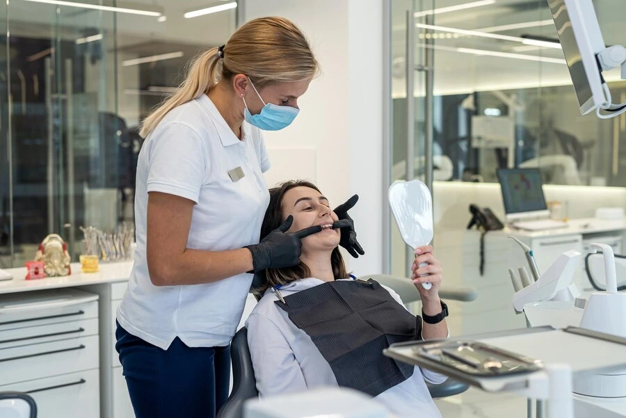 smiling happy female dentist girl patient smiling looking their white teeth mirror 359031 40664